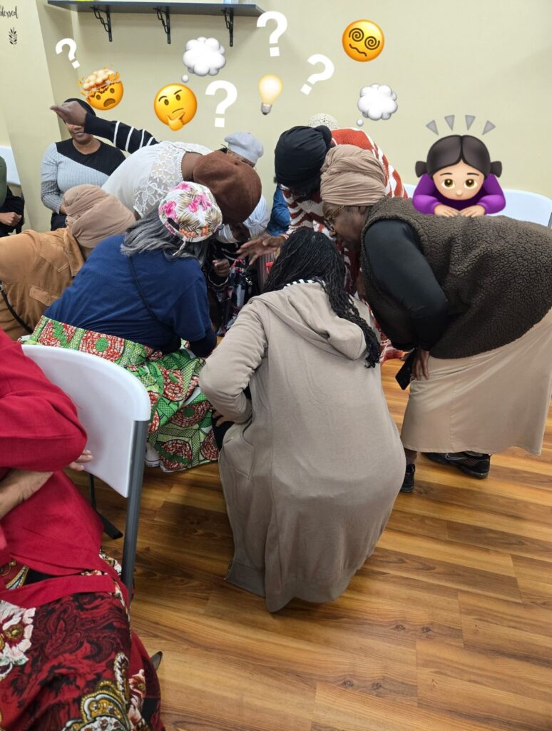 A group of women gather closely, intensely discussing or solving a puzzle. Their expressions show curiosity and engagement, enhancing community interaction.